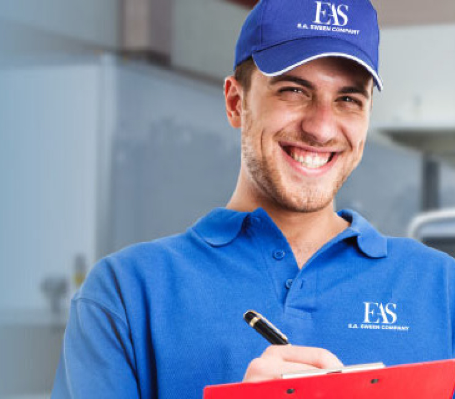 E.A. Sween employee writing on clipboard